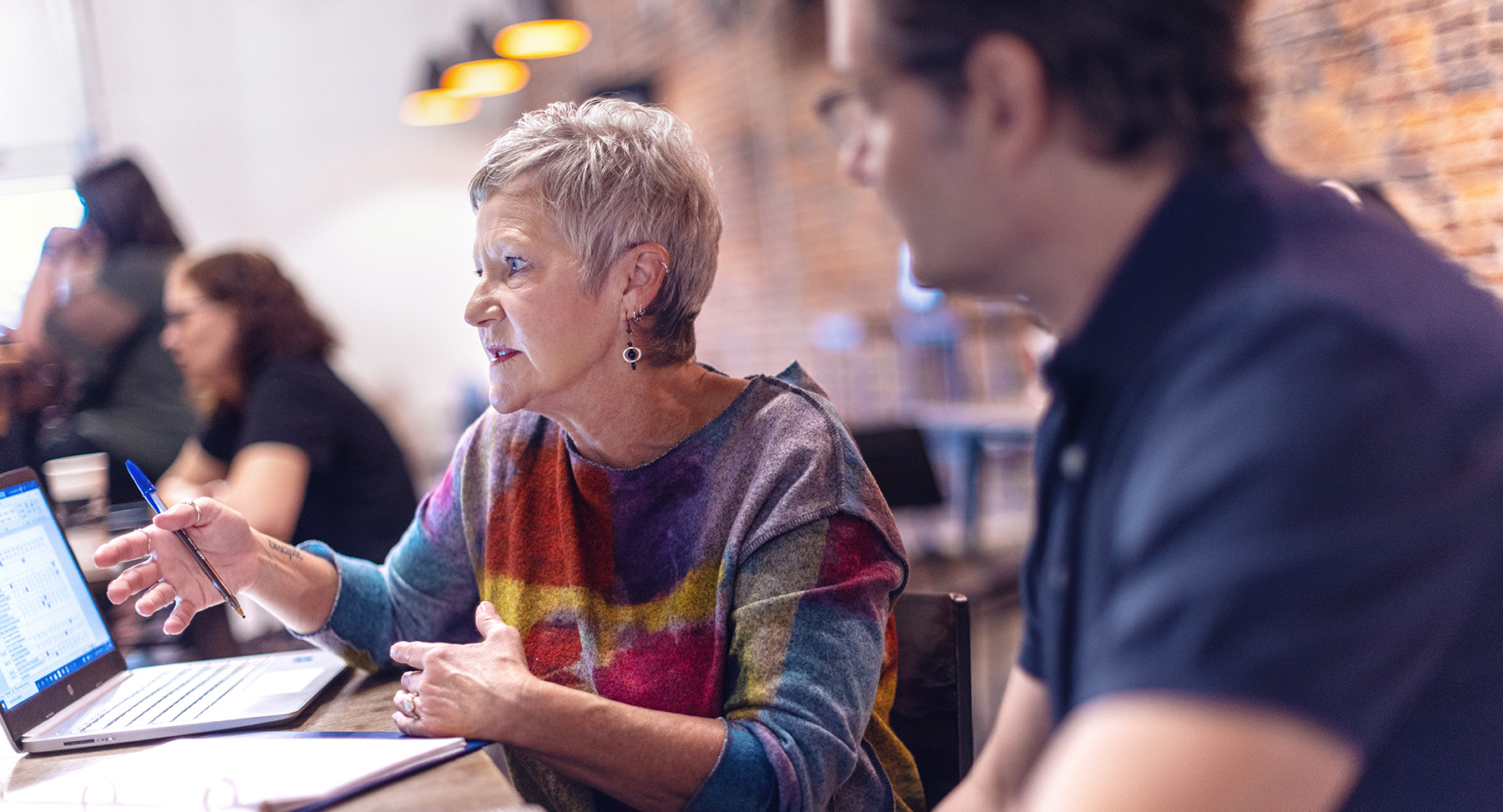 Adult Students having a discussion on a laptop