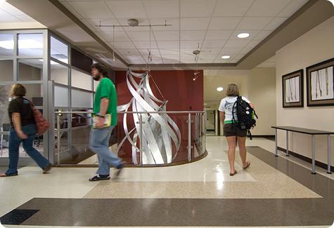 Students walk past art installation in Owens Hall