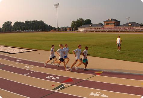 Students running on the Irwin Belk track