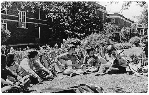Historical photo of a group of male and female students outside