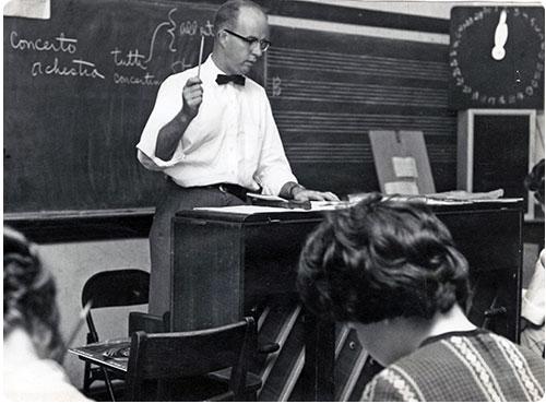 Historical photo of a music professor teaching a class