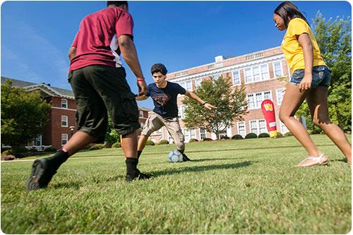 Students playing soccer outside