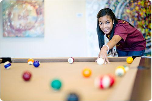 Student playing pool