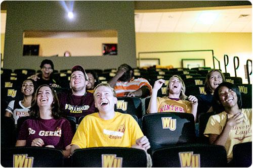 Students laughing at a movie in Dina's Place theatre