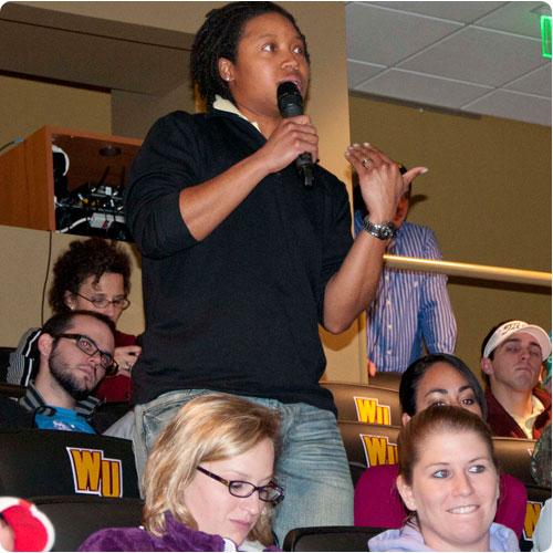 A student asks a question of Mike Collins and Dr. Scott Huffmon