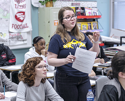 A student teacher teaching in a classroom.