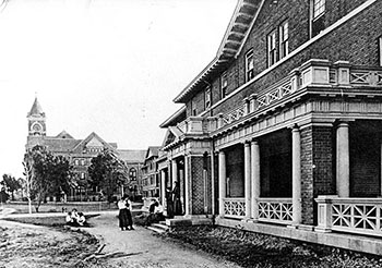 a black and white photo of the front of Bancroft Hall in 1912 with Tillman hall visible
                              in the background