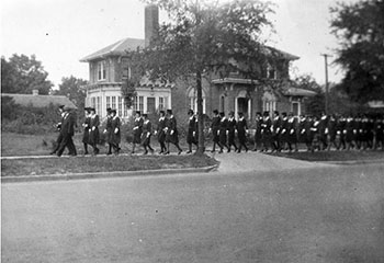 Winthrop students in matching uniforms walking down the street in a line together