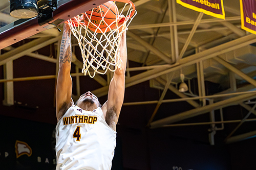 Close up shot of Men's Basketball Player Kelton Talford dunking the ball