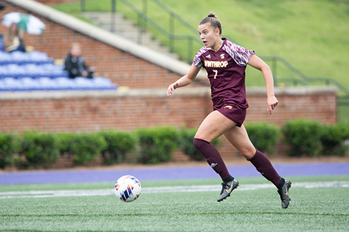 Women's soccer player Sophia Balliet about to kick the ball