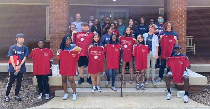 History Students With Shirts On Front Porch