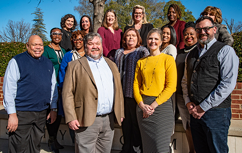 A group photo of Social Work faculty gathered outside on a sunny day