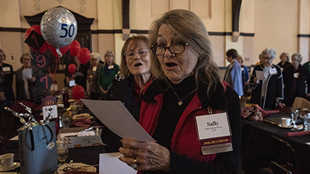 Alumni from the class of 1973 singing the alma mater at their homecoming reunion luncheon