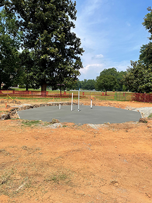 new concrete has been poured into the hole where the old fountain was located