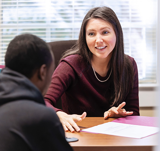 A financial aid counselor talking to a student