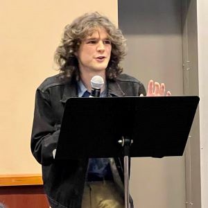 A student reader performing at the 2023 Creative Writing Student Showcase. A student reader performing at the 2023 Creative Writing Student Showcase.