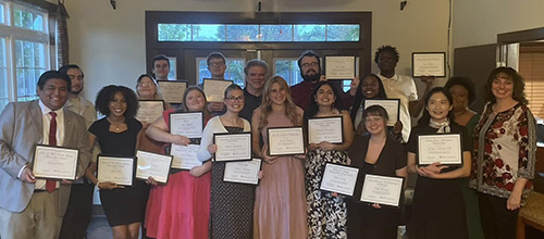 group photo of students holding up award certificates