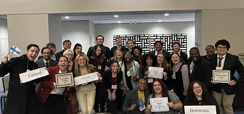 group photo of model un participants holding up award certificates