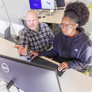 A student and a professor work at a computer