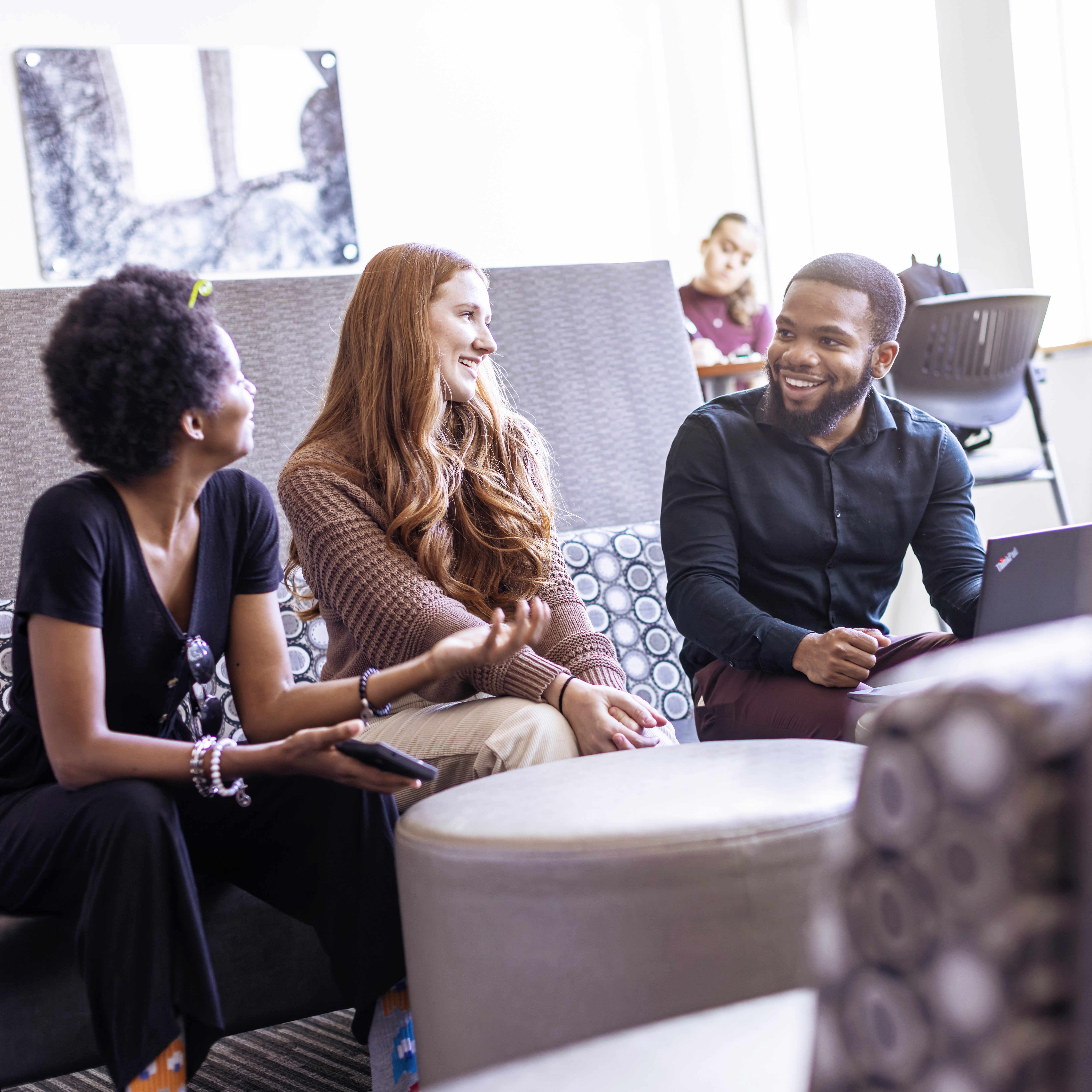 Students conversing in a lounge.