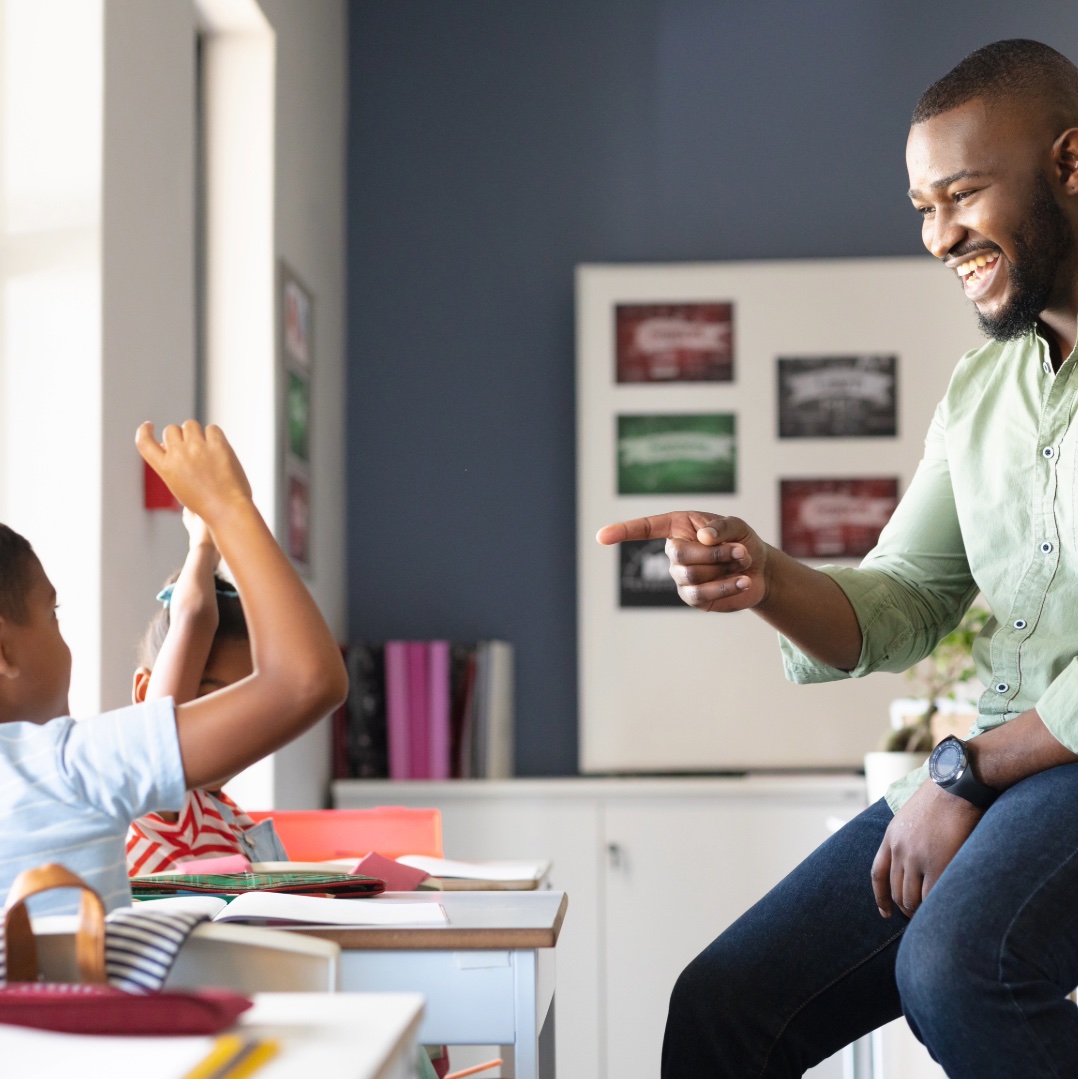 Smiling teacher interacting with student
