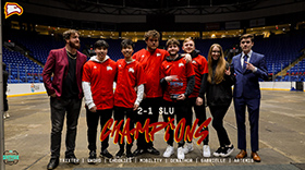 Winthrop League of Legends Team in the arena with text that reads 2-1 SLU Champions.
                        Trixter, Sword, Chookies, Mobility, Denathor, Gabrielle, Artemis