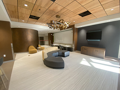 Clean lobby with shiny light fixture and round furniture