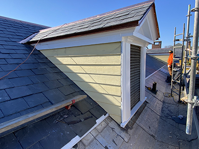 Dormer window showing light-colored siding