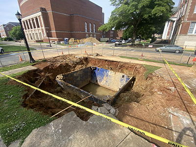 Dirt pit with yellow caution tape around it