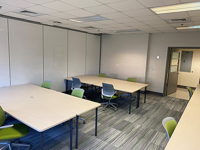 New lab in Sims Building featuring meeting tables and blue- and green chairs