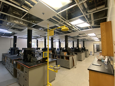 Lab space with ceiling tiles missing and construction equipment
