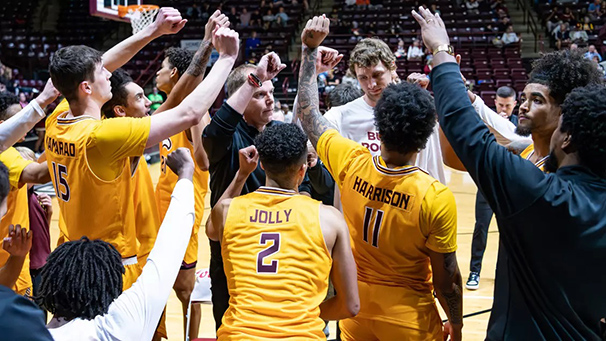 basketball team huddling on the court