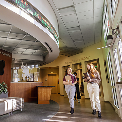two students walking in Carroll Hall