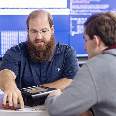 faculty member talking to student
