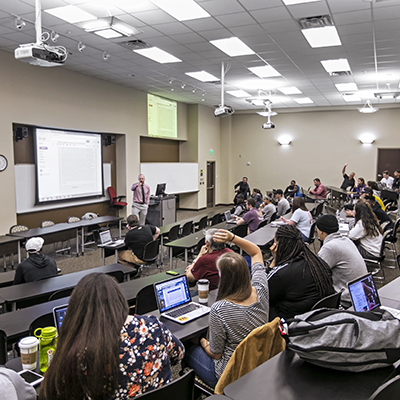 Students listening to a professor in a lecture hall
