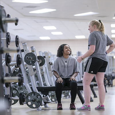 Two students in the West Center weight room