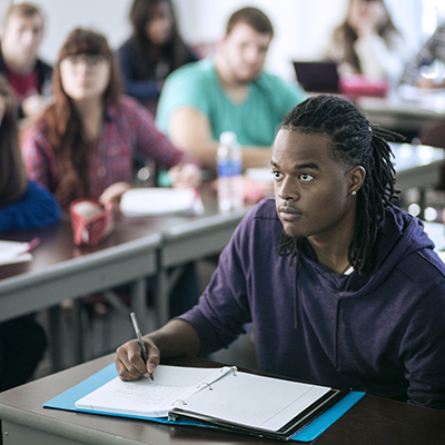Student taking notes in class