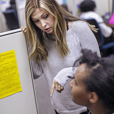 The operations manager speaks to a student conducting a poll