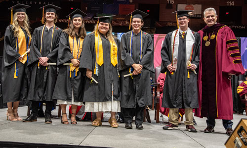 Isabella Thomas, from left, Lucas Robenolt, Caitlin Lonardo, Kathryn Kiser, Evelyn Conran, Joseph Bokern and President Serna 