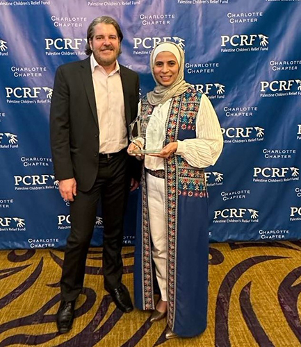 Duha Hamed, right, receiving her award