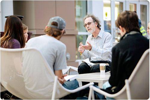 Professor talks to students in an outdoor setting