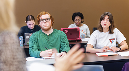 students in a classroom listening to the professor