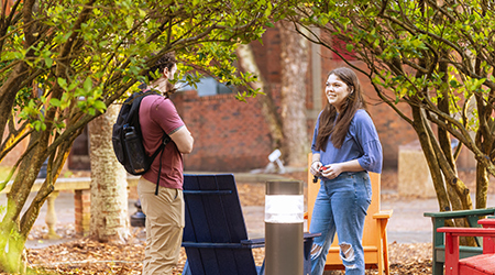 two students talking in hardin gardens