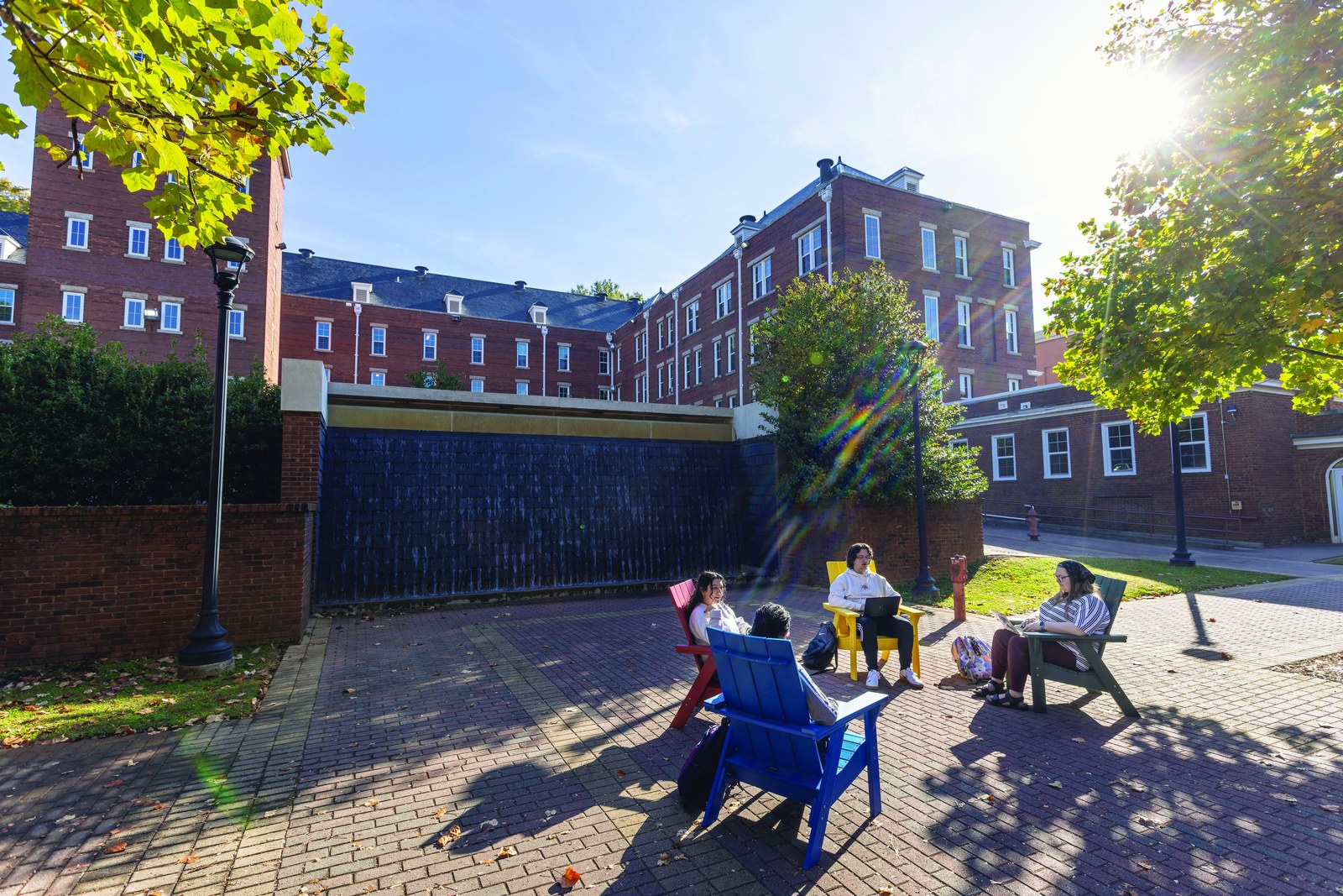 Students sitting together outside on campus