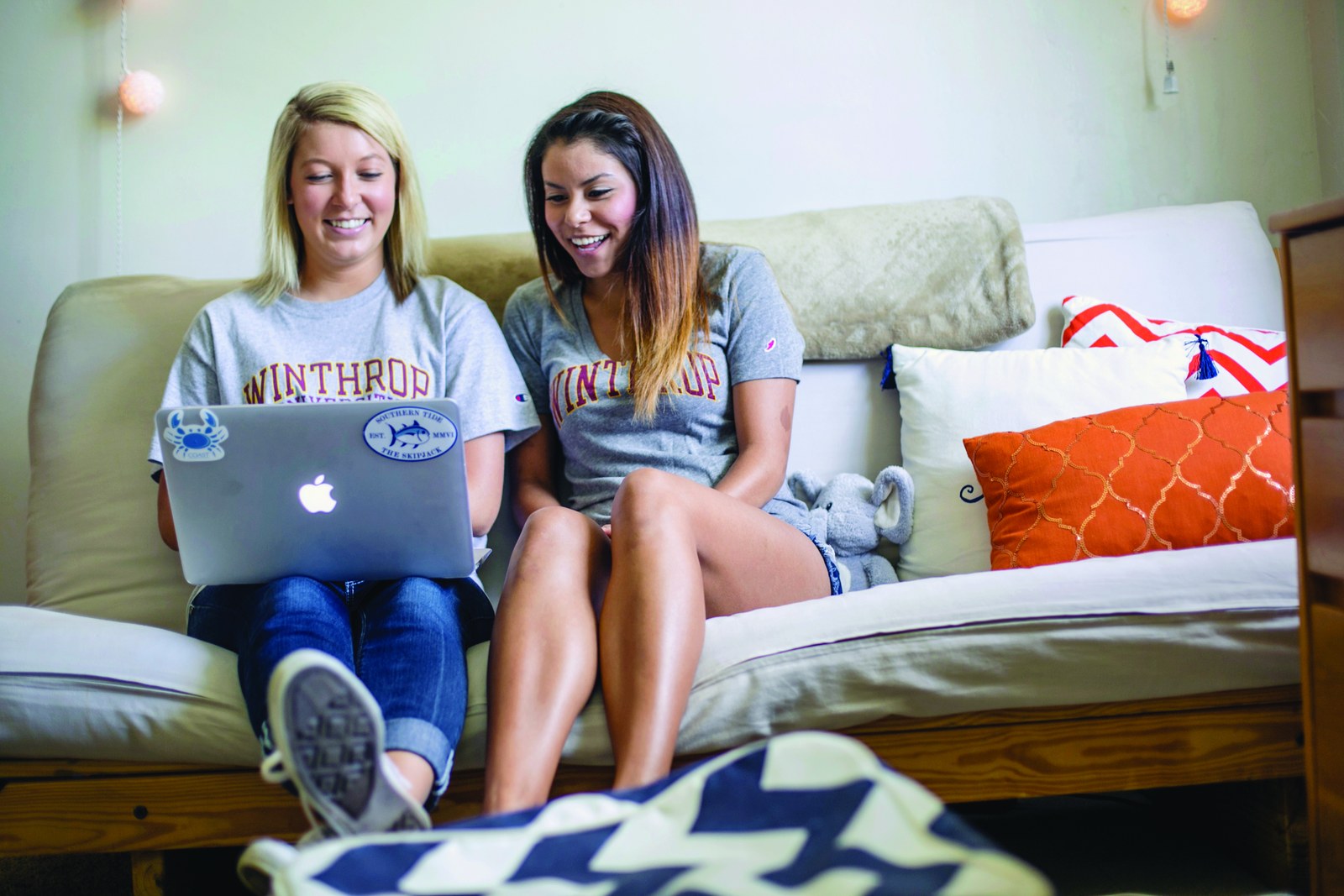 Two students sitting together in a residence hall room