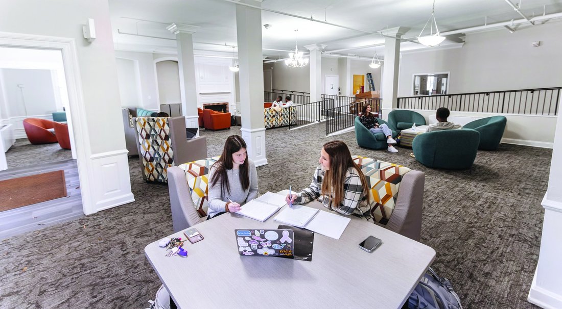 Students studying together in a residence hall common area