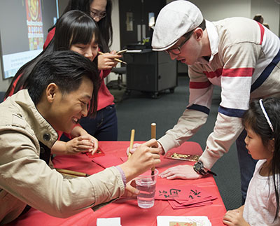 international students from southeast asia sharing their culture at a student event