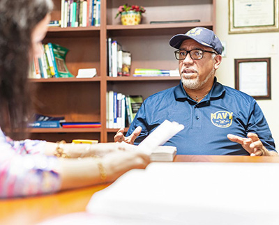 a veteran student speaking with a faculty advisor in her office