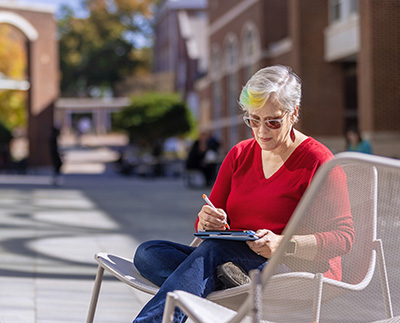 a non-traditional student studying outside of the student center