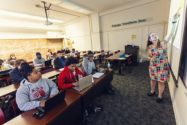 a professor teaching to a class of 12 students